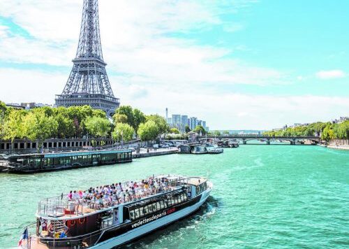 Cruise ship on the river Seine with Eiffel Tower in background