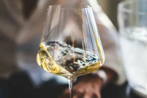 White wine in glass during wine tasting