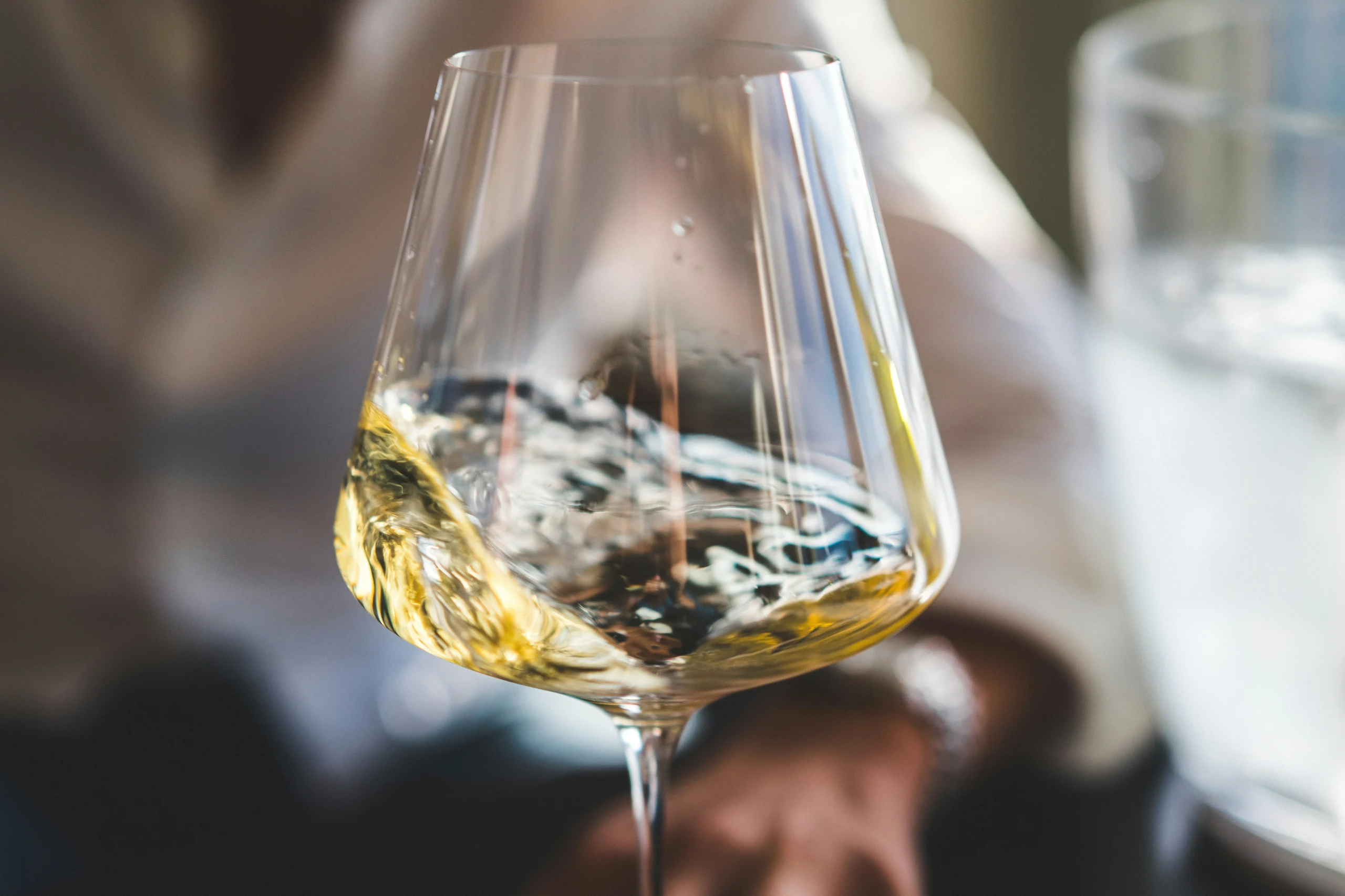 White wine in glass during wine tasting