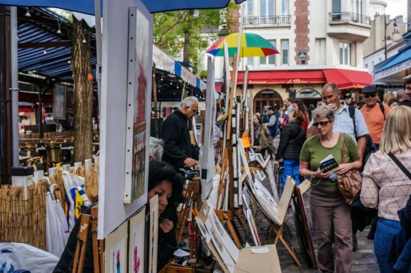 People in street markets in Montmartre during Heart of Paris private tour