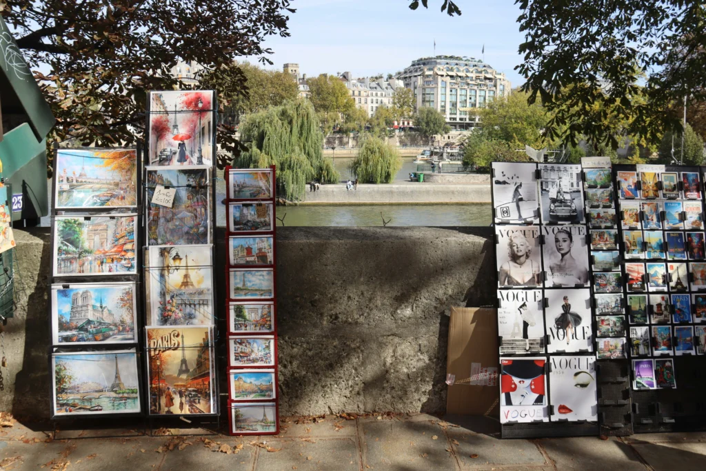 Artwork displayed along Paris riverbank with buildings in background